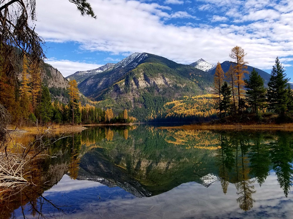 Glassy lake with a mountain in the background