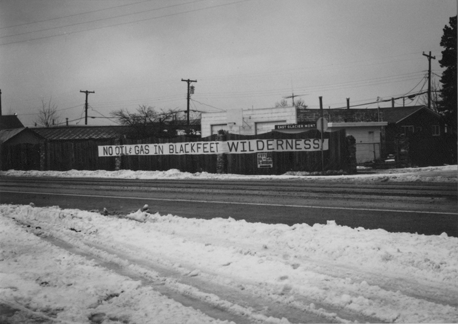 Historical photo of a sign protesting oil and gas drilling in Blackfeet Wilderness