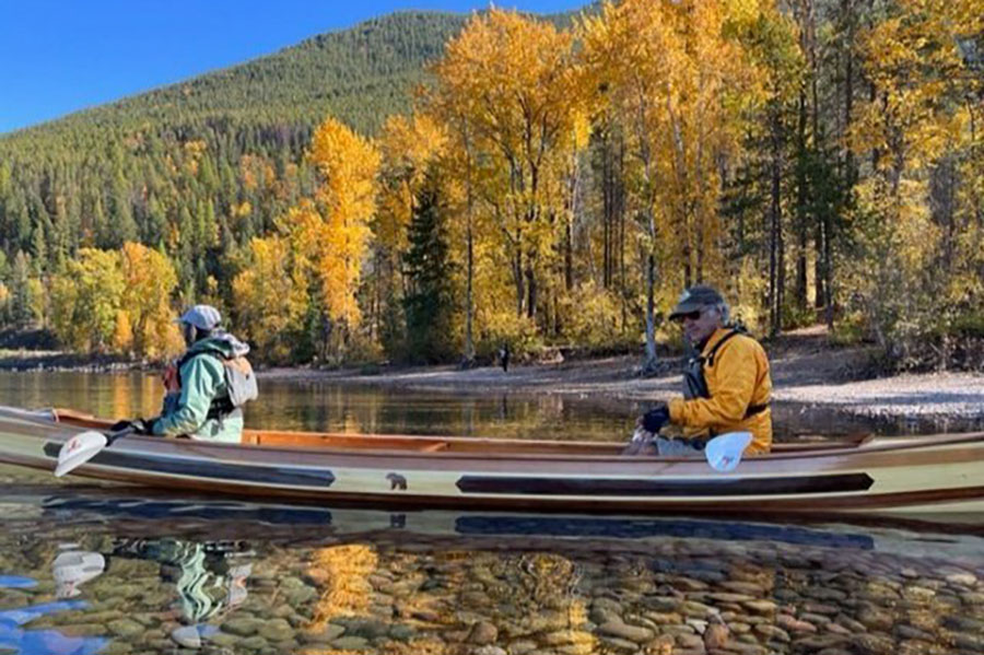 Lucky winners Leslie and Carl Haggar take the new canoe for its maiden voyage on Lake McDonald.