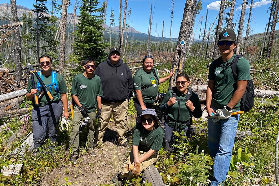 Young Blackfeet tribal members hiking and doing trail maintenance