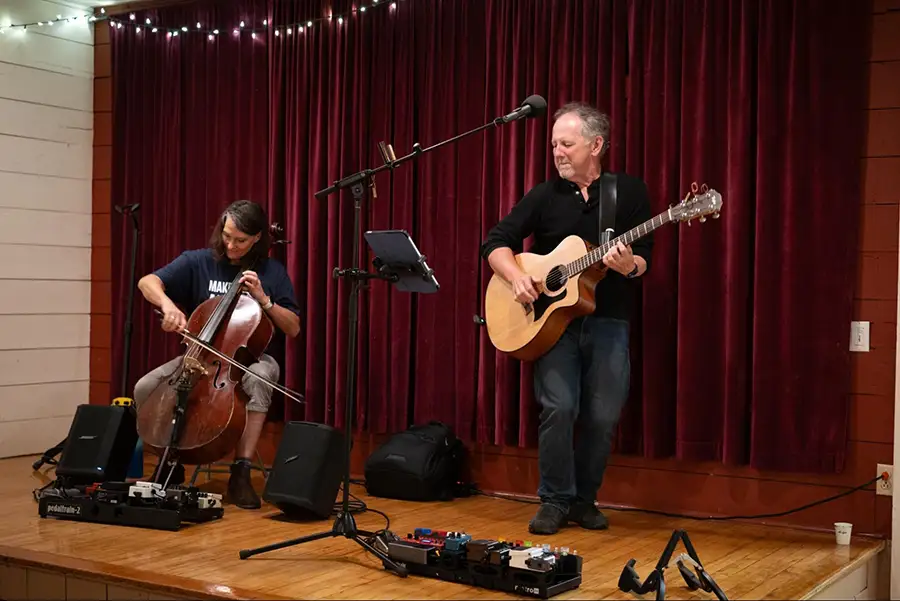 The John Floridis Trio playing live music on stage during the 2026 Fall Gathering